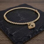 Geel gouden armband met harten hanger