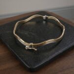 Gouden bicolor slavenarmband golvend model