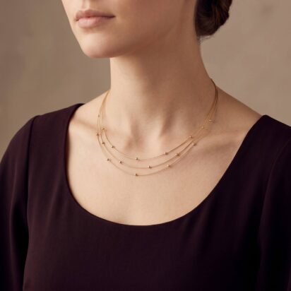 Gouden choker met balletjes