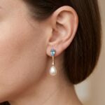 Gouden oorbellen met topaas, diamant en parel
