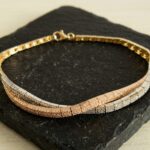 14 karaat geel-, wit en rosé gouden armband met zirkonia