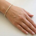 Bicolor Christian gouden schakelarmband