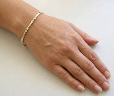 Bicolor Christian gouden schakelarmband