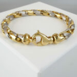 Christian armband bicolor goud