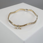 Gouden bicolor slavenarmband golvend model