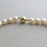 Parel collier met gouden slot