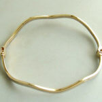 Gouden bicolor slavenarmband golvend model