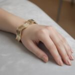 Gouden tricolor slavenarmband golvend model