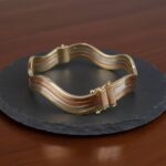 Gouden tricolor slavenarmband golvend model