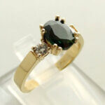 Christian gouden ring met groene saffier