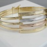 Gouden tricolor slavenarmband