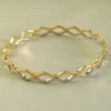 14 karaat geel- en wit gouden slavenarmband14 karaat geel- en wit gouden slavenarmband