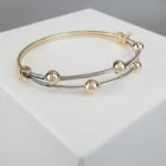 Bicolor slavenarmband met balletjes