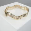 Gouden tricolor slavenarmband golvend model