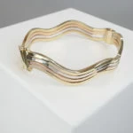 Gouden tricolor slavenarmband golvend model