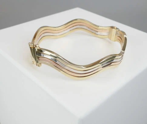 Gouden tricolor slavenarmband golvend model