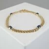 Gouden armband met diamant en saffier