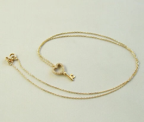 Gouden ketting en zirkonia harten sleutelhanger