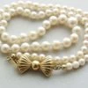 Parel collier met gouden strik slot