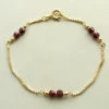 14 karaat geel gouden armband met granaat