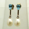 Gouden oorbellen met topaas, diamant en parel
