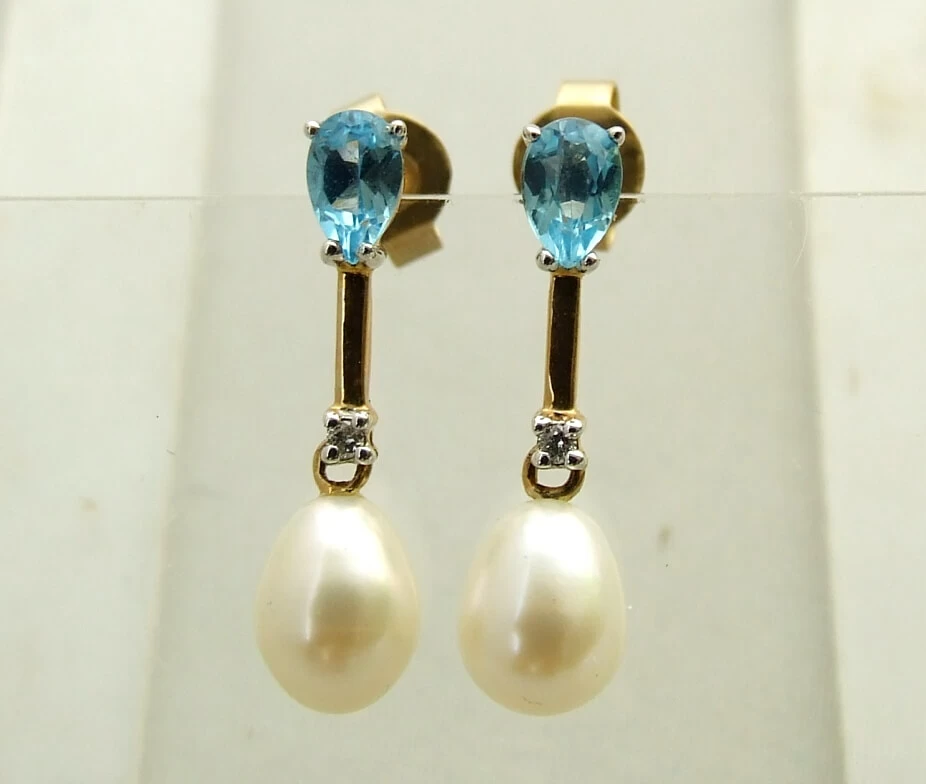 Gouden oorbellen met topaas, diamant en parel