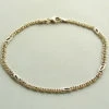 Gouden schakelarmband bicolor